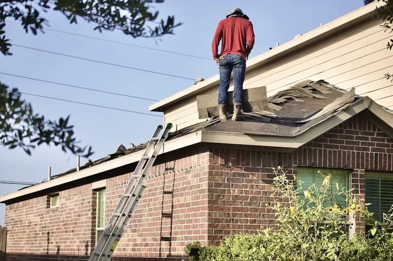 Professional roofer working on a residential roof in Briarwood Acres